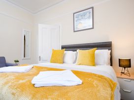 A bedroom with a bed and decorative items at 46 Ashville Avenue Scarborough
