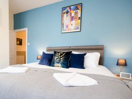 A bedroom with a bed, pillows, and a painting at 46 Ashville Avenue Scarborough