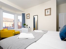 A bedroom with a bed and a mirror at 46 Ashville Avenue in Scarborough