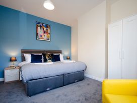 A bedroom with a bed and a wardrobe at 46 Ashville Avenue in Scarborough