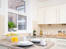 A kitchen with a sink and fruit on the counter at 46 Ashville Avenue Scarborough