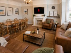 A living room with a dining table and sofa at 46 Ashville Avenue in Scarborough