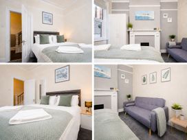 A bedroom with a bed and sofa at 46 Ashville Avenue in Scarborough