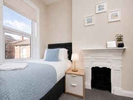 A bedroom with a bed and nightstand at 46 Ashville Avenue in Scarborough