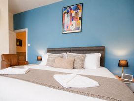 A bedroom with a bed and armchair at 46 Ashville Avenue in Scarborough