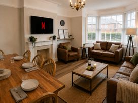 A living room with a television and seating area at 46 Ashville Avenue Scarborough