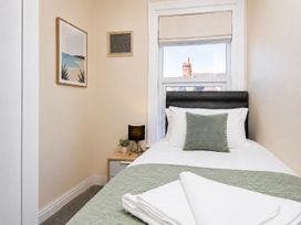A bedroom with a single bed and artworks on the wall at 46 Ashville Avenue Scarborough