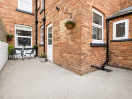 A patio with a table and chairs at 46 Ashville Avenue in Scarborough
