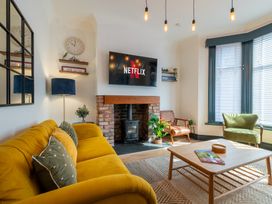 A living room with a TV and a sofa at 22 Ashville Avenue, Scarborough