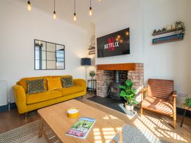 A living room with a television and fireplace at 22 Ashville Avenue in Scarborough