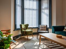 A living room with chairs and a coffee table at 22 Ashville Avenue Scarborough