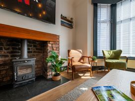 A living room with a fireplace and two armchairs at 22 Ashville Avenue, Scarborough