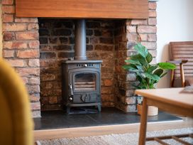 A living room with a stove and plant at 22 Ashville Avenue in Scarborough