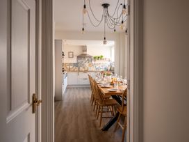 A dining area with a table and chairs overlooking a kitchen at 22 Ashville Avenue Scarborough
