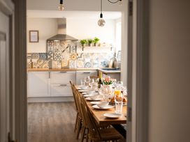 A kitchen with a dining table set for a meal at 22 Ashville Avenue, Scarborough