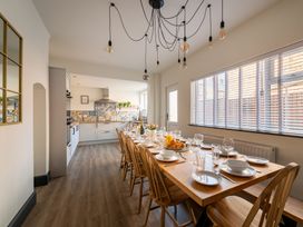 A kitchen with a dining table set for a meal at 22 Ashville Avenue in Scarborough