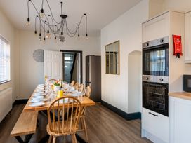 A kitchen with a dining table and chairs at 22 Ashville Avenue, Scarborough