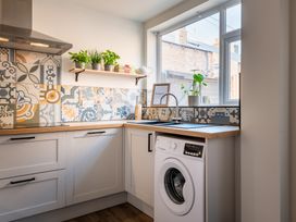A kitchen featuring a washing machine and sink at 22 Ashville Avenue, Scarborough