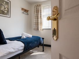 A bedroom with a bed and towels at 22 Ashville Avenue in Scarborough