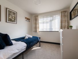 A bedroom with a bed and dresser at 22 Ashville Avenue in Scarborough