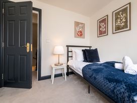 A bedroom with a bed and artwork at 22 Ashville Avenue Scarborough