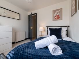 A bedroom with a bed and dresser at 22 Ashville Avenue in Scarborough