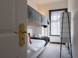 A bedroom with a bunk bed and window at 22 Ashville Avenue in Scarborough