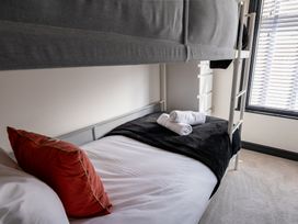 A bedroom with a bunk bed and a twin bed at 22 Ashville Avenue Scarborough