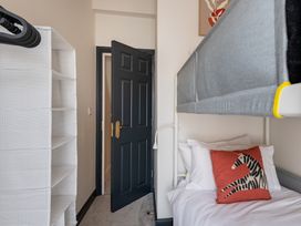 A bedroom with a bunk bed and storage shelf at 22 Ashville Avenue, Scarborough