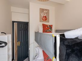 A bedroom with a bunk bed and wall art at 22 Ashville Avenue in Scarborough