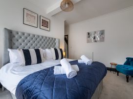 A bedroom with a bed and a chair at 22 Ashville Avenue, Scarborough