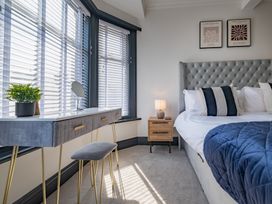 A bedroom with a bed and a desk at 22 Ashville Avenue in Scarborough