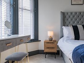 A bedroom with a bed and a nightstand at 22 Ashville Avenue Scarborough