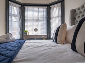 A bedroom with a bed and window in a house at 22 Ashville Avenue, Scarborough