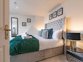 A bedroom with a bed and decorative items at 22 Ashville Avenue in Scarborough