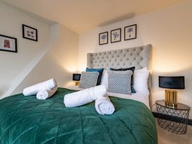 A bedroom with a bed and bedside table at 22 Ashville Avenue in Scarborough