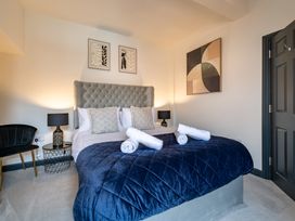 A bedroom with a bed and a chair at 22 Ashville Avenue, Scarborough