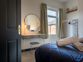 A bedroom with a desk and mirror at 22 Ashville Avenue Scarborough