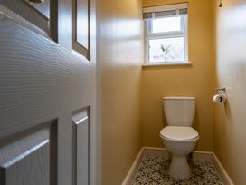 A bathroom with a toilet and window at 22 Ashville Avenue in Scarborough