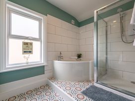 A bathroom with a bathtub and shower at 22 Ashville Avenue, Scarborough