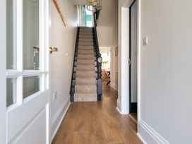 A hallway with stairs and a door at 22 Ashville Avenue Scarborough