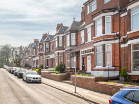 A street with several houses and parked cars at 22 Ashville Avenue, Scarborough