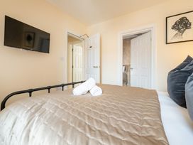 A bedroom with a bed and television at The Ravines in Scarborough