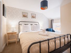 A bedroom with a bed and bedside table at The Ravines in Scarborough