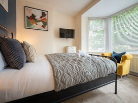 A bedroom with a bed and television at The Ravines in Scarborough