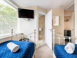 A bedroom with two beds and a television at The Ravines in Scarborough
