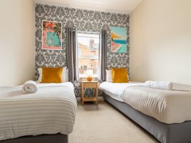 A bedroom with twin beds and a bedside table at The Ravines in Scarborough