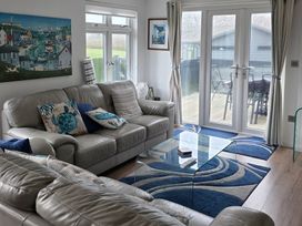 A living room with a sofa and glass table at Hoburne Naish - HE16 Seaclusion New Milton
