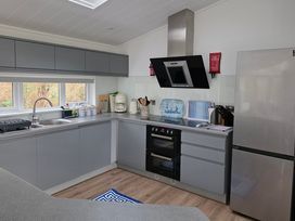 A kitchen with cabinets and appliances at Hoburne Naish - HE16 Seaclusion in New Milton