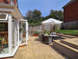 A garden with seating area and plants at Manning's View in Barnstaple